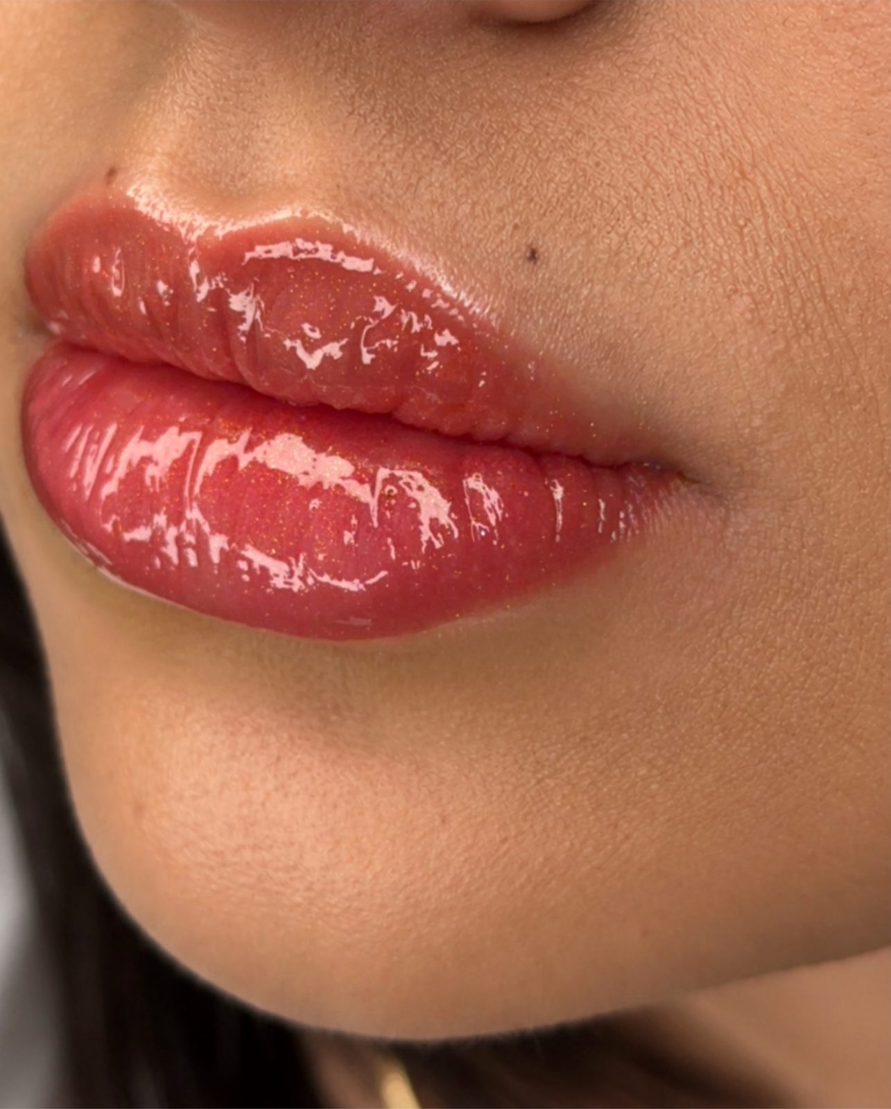 Close-up of super natural lip blush in a soft rosy red with glossy finish