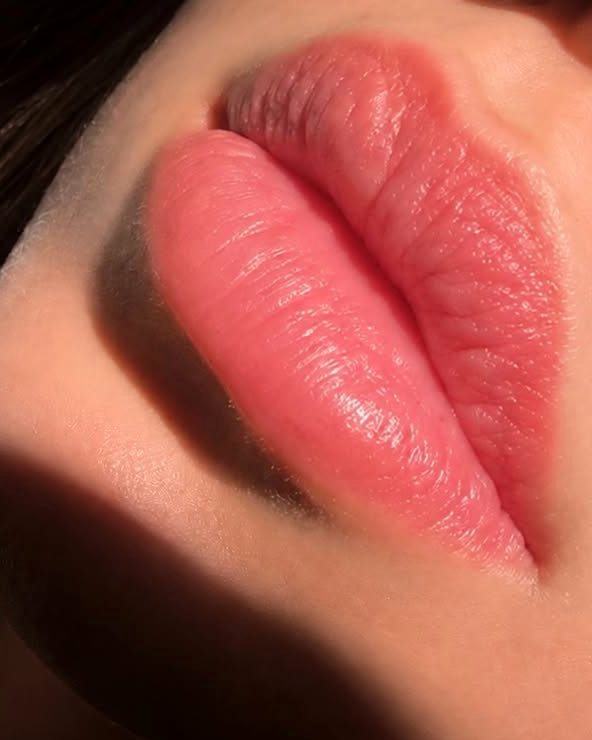 Healed lip blush one month after the touch-up session: soft, even natural pink lips in warm side light